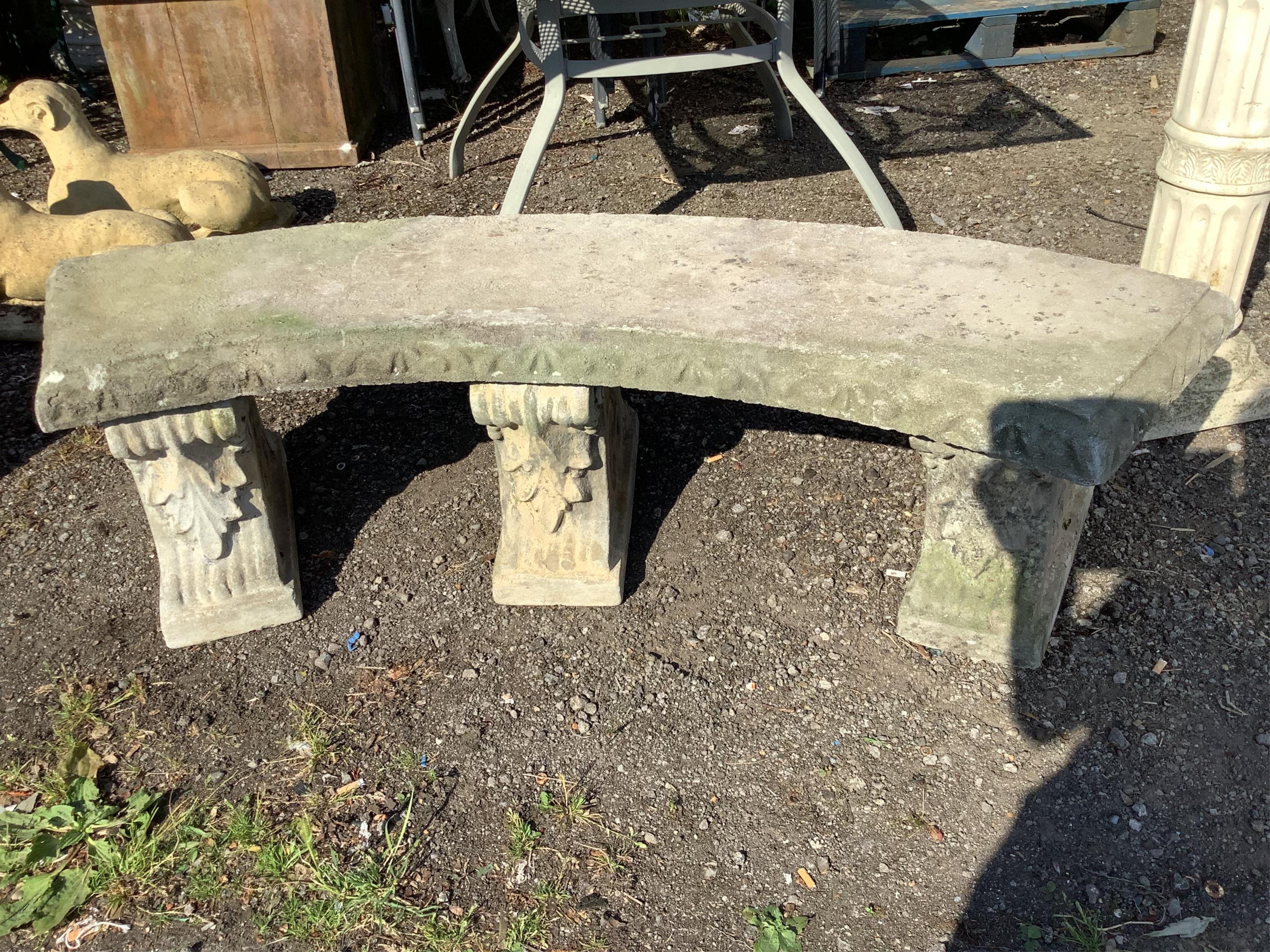 A large reconstituted stone curved garden bench, width 160cm, depth 39cm, height 42cm. Condition - good